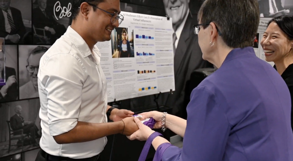Graduate student Royal Shrestha receives recognition for his project during the Schieffer Showcase on April 16, 2025, in Moudy South. (Photo courtesy of Haylee Chiariello)